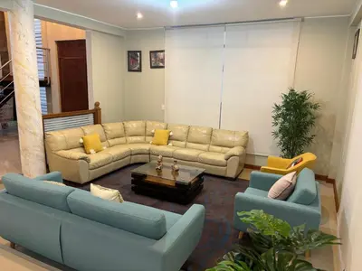 a living room with two couches and a table at Villa Luna in Cieneguilla