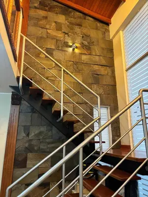 a metal spiral staircase in a stone wall at Villa Luna in Cieneguilla