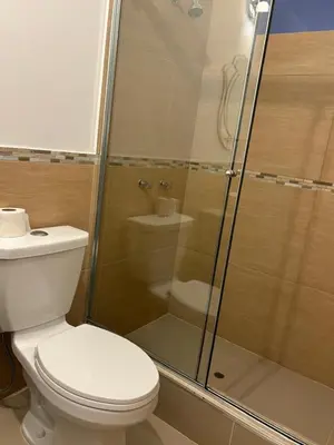 a bathroom with a toilet and a glass shower at Villa Luna in Cieneguilla