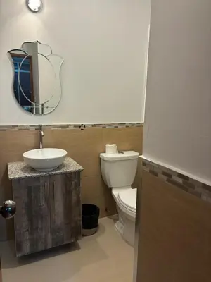 a bathroom with a toilet and a sink and a mirror at Villa Luna in Cieneguilla