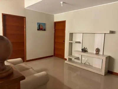 a living room with a couch and a mirror at Villa Luna in Cieneguilla