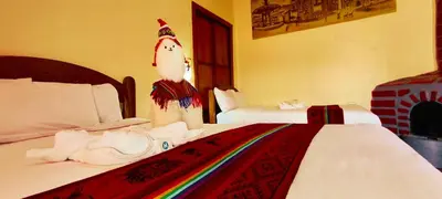 a room with two beds with a unicorn on the wall at PLAZA cusco Amankay in Cusco