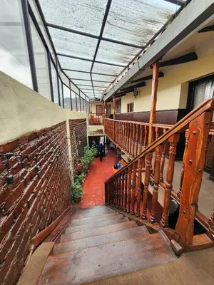 a staircase in a building with a wooden railing at PLAZA cusco Amankay in Cusco