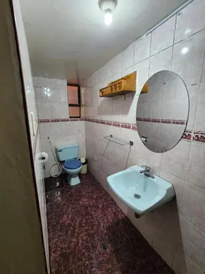a bathroom with a sink and a toilet and a mirror at PLAZA cusco Amankay in Cusco