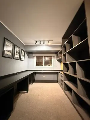 a dark room with a window and a long desk at Beautiful penthouse in the heart of Miraflores in Lima