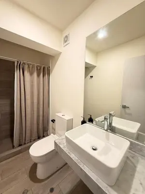 a white bathroom with a sink and a toilet at Beautiful penthouse in the heart of Miraflores in Lima