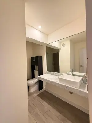 a bathroom with a sink and a toilet and a mirror at Beautiful penthouse in the heart of Miraflores in Lima