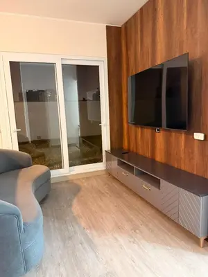 a living room with a couch and a flat screen tv at Beautiful penthouse in the heart of Miraflores in Lima
