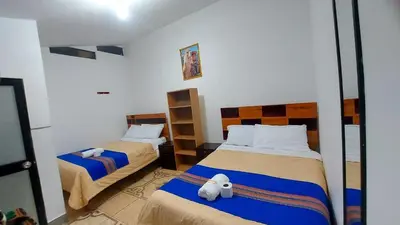a bedroom with two beds with a stuffed animal on the bed at Altos Del Valle in Cusco