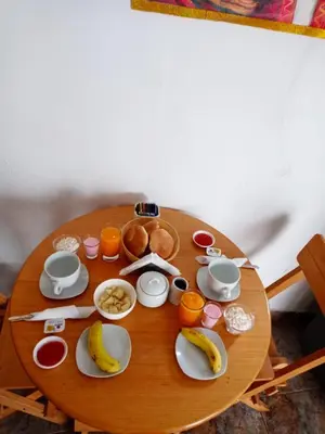 a wooden table with food and fruit on it at Altos Del Valle in Cusco