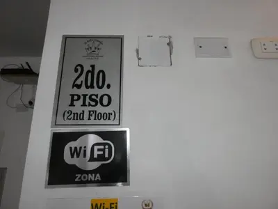a wall with signs on the wall of a room at Hotel Lima Norte in Carabayllo