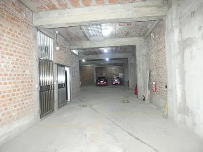 a tunnel with two cars parked inside of a building at Hotel Lima Norte in Carabayllo