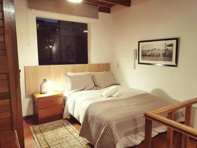a bedroom with a bed and a window at Casa Cota in Lima