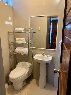 a bathroom with a toilet and a sink at Suite C-1 Wifi 1000 Mbps, recojo gratis aeropuerto in Lima