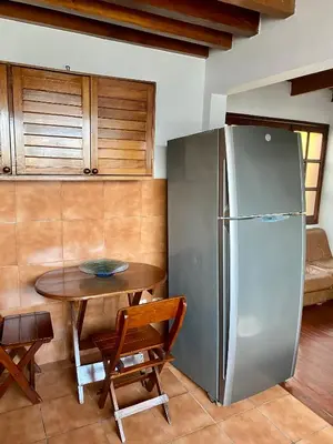 a kitchen with a stainless steel refrigerator and a table at Suite C-1 Wifi 1000 Mbps, recojo gratis aeropuerto in Lima
