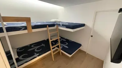 a small room with two bunk beds and a ladder at Casa Playa Azul Verano 2026 Asia in Cerro Azul