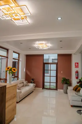 a large living room with couches and windows at HOTEL TERRANOVA Abancay in Abancay