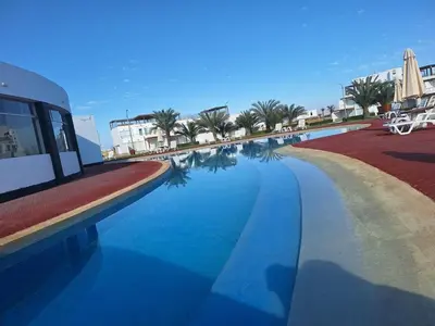 a view of a swimming pool at a resort at Paracas Exclusivo Departamento familiar in Pisco