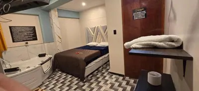 a small room with a bed and a bath tub at Hotel gym club33 in Huancayo