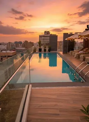 a swimming pool on the roof of a building at Business Class Suite Miraflores! in Lima