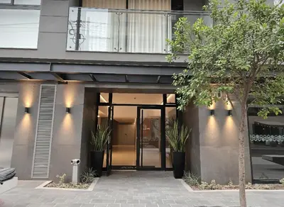 a building with a glass door with potted plants at Business Class Suite Miraflores! in Lima