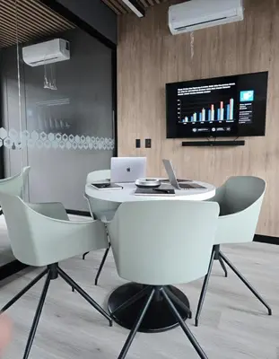 a white table and chairs in a room with a laptop at Business Class Suite Miraflores! in Lima