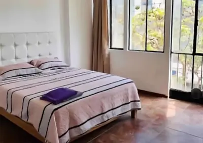 a bedroom with a bed with a purple towel on it at Smart apart in Lima