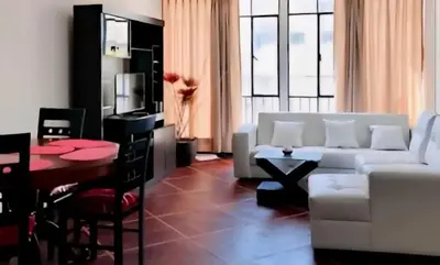 a living room with a white couch and a table at Smart apart in Lima