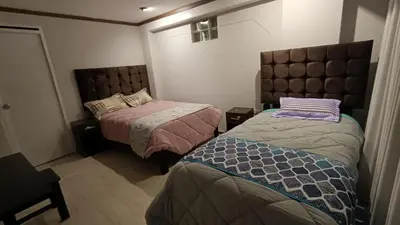 a room with two beds in a room at Hotel Wasichay - Santa teresa in Santa Teresa