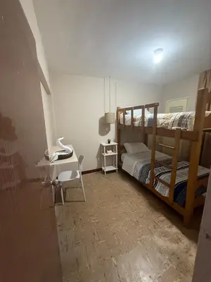a bedroom with two bunk beds and a desk at Apartment in Lima's historic center in Lima