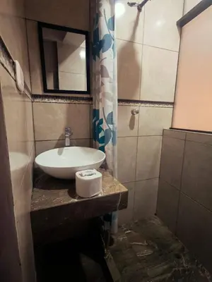a bathroom with a sink and a mirror at Refugio Andino Cusco in Cusco