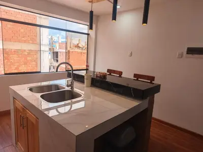 a kitchen with a sink and a large window at Refugio Andino Cusco in Cusco