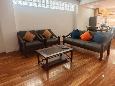 a living room with two couches and a coffee table at Refugio Andino Cusco in Cusco