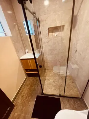 a shower with a glass door in a bathroom at Estancia Ideal in Lima