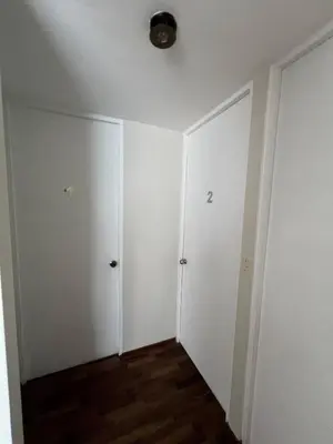an empty room with white walls and wood floors at Prescott Apartment San Isidrio in Lima