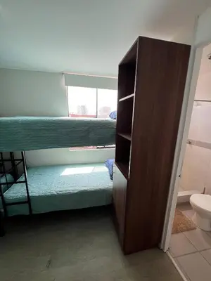 a room with two bunk beds and a closet at Prescott Apartment San Isidrio in Lima