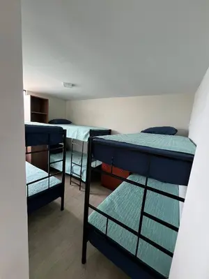 a room with three bunk beds in a dorm at Prescott Apartment San Isidrio in Lima