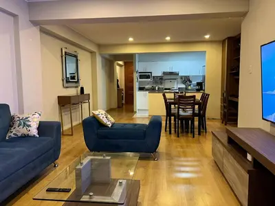 a living room with a couch and a tv and a table at Room with 2 beds - Shared Apartment in Lima
