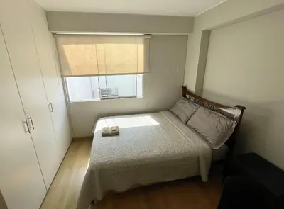 a small bedroom with a bed and a window at Room with 2 beds - Shared Apartment in Lima