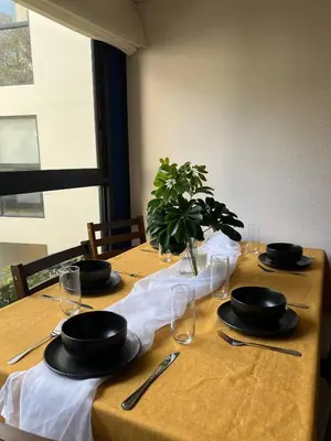 a table with plates and glasses on top at Modern Apartment for 9 San Isidro in Lima