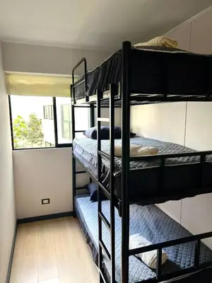 two bunk beds in a room with a window at Modern Apartment for 9 San Isidro in Lima