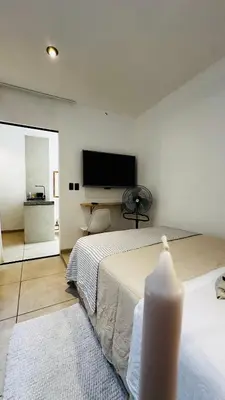 a bedroom with a bed and a flat screen tv at Mini in Punta Hermosa