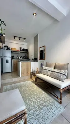 a living room with a couch and a kitchen at Mini in Punta Hermosa