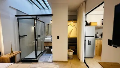 a bathroom with a glass shower and a toilet at Mini in Punta Hermosa
