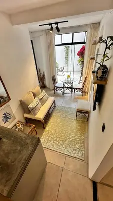 a living room with a couch and a table at Mini in Punta Hermosa