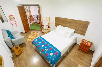 a bedroom with a bed and a guitar in a room at Casona MICA'S HOUSE in Cusco