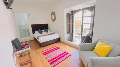 a living room with a bed and a couch at Casona MICA'S HOUSE in Cusco