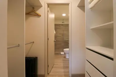 a bathroom with a toilet and a walk in closet at Larco by Wynwood House in Lima