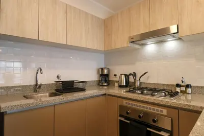 a kitchen with a sink and a stove top oven at Larco by Wynwood House in Lima