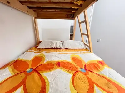 a bed in a room with a colorful bedspread at Chincha CasaLed y jacuzzis sol todo el año in Tambo de Mora